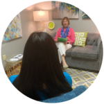 two women seated and speaking